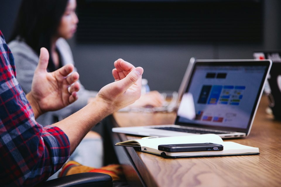 People in a meeting with using hands to communicate 